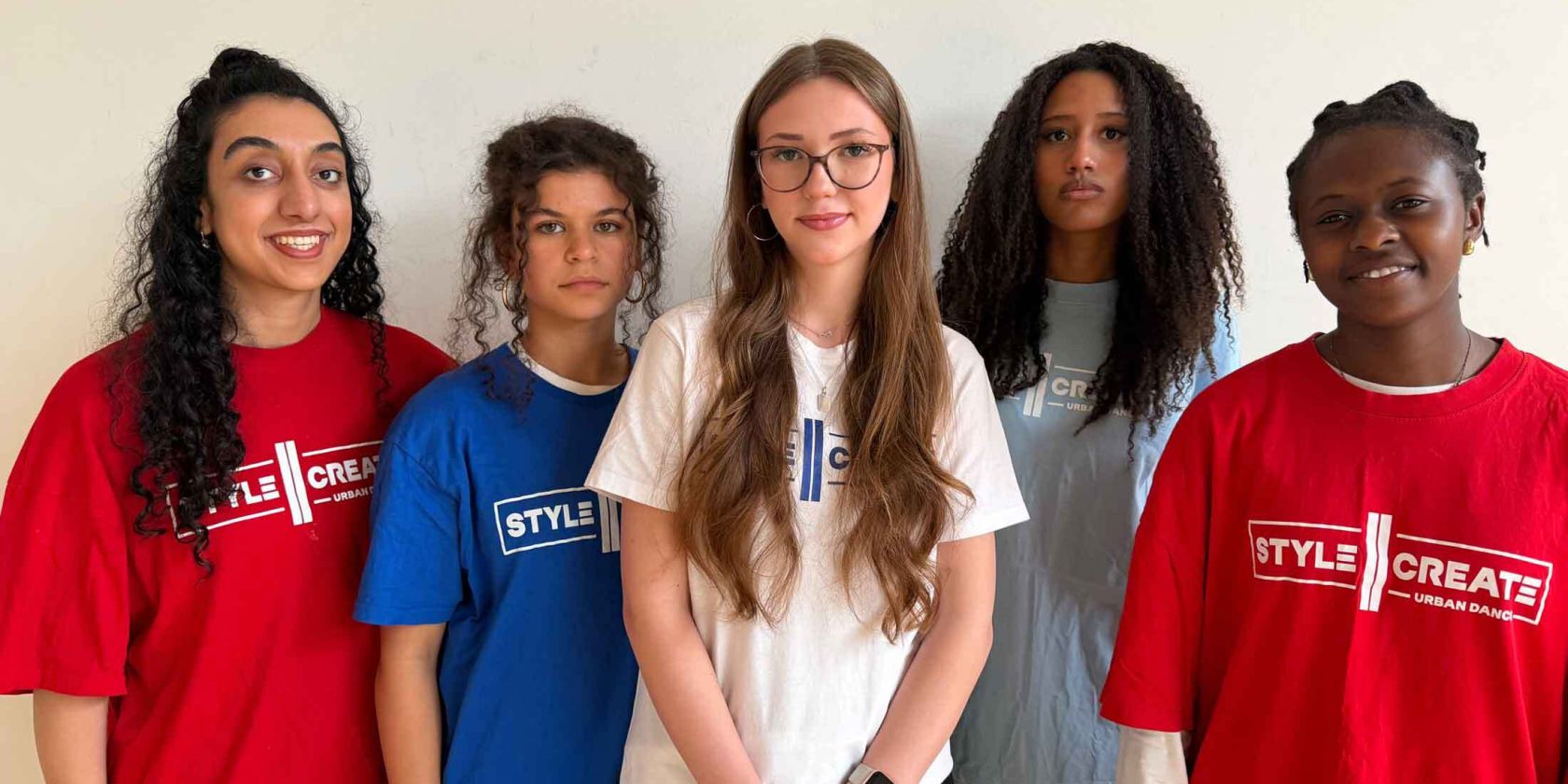 Fünf Personen mit unterschiedlichen Haarlängen und -strukturen tragen bunte T-Shirts mit dem Schriftzug "STYLE CREATE" und stehen vor einer hellen Wand., © Hajusom Fünf Personen mit unterschiedlichen Haarlängen und -strukturen tragen bunte T-Shirts mit dem Schriftzug "STYLE CREATE" und stehen vor einer hellen Wand., © Hajusom